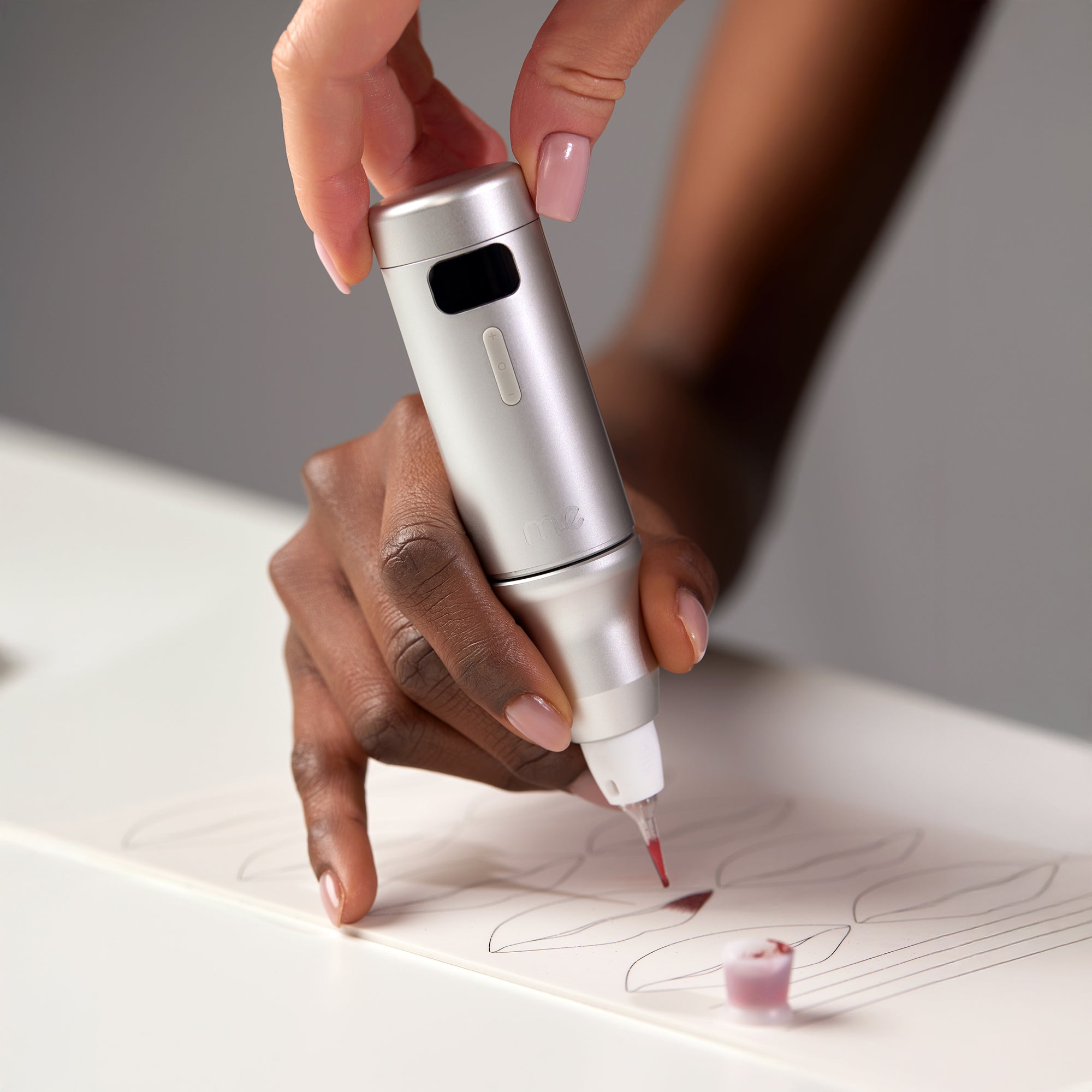 ME™ wireless permanent makeup machine used by a beginner artist on a PMU practice skin.