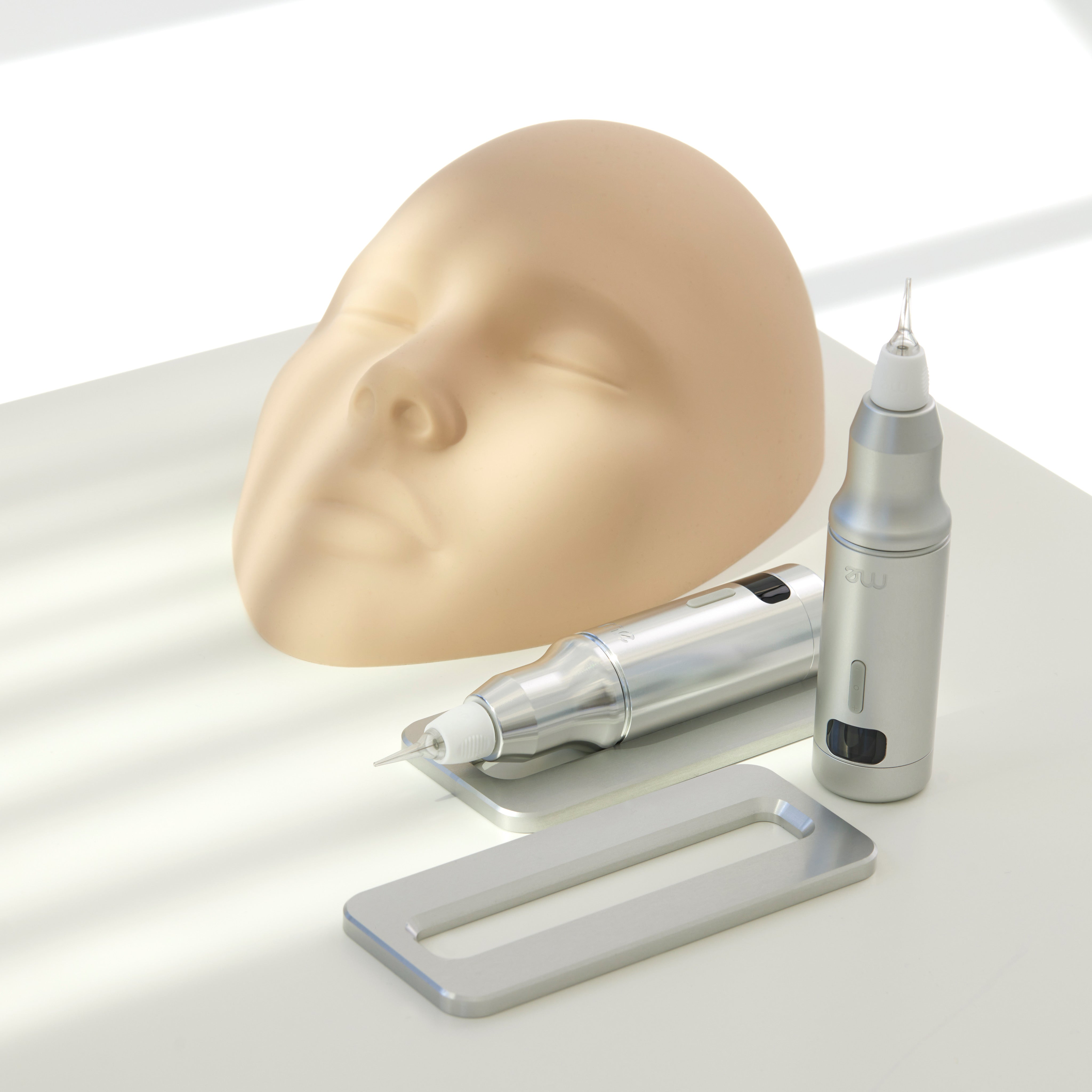 Professional PMU machine ME with silicone face model for permanent makeup training, designed for precision and pigment implantation.